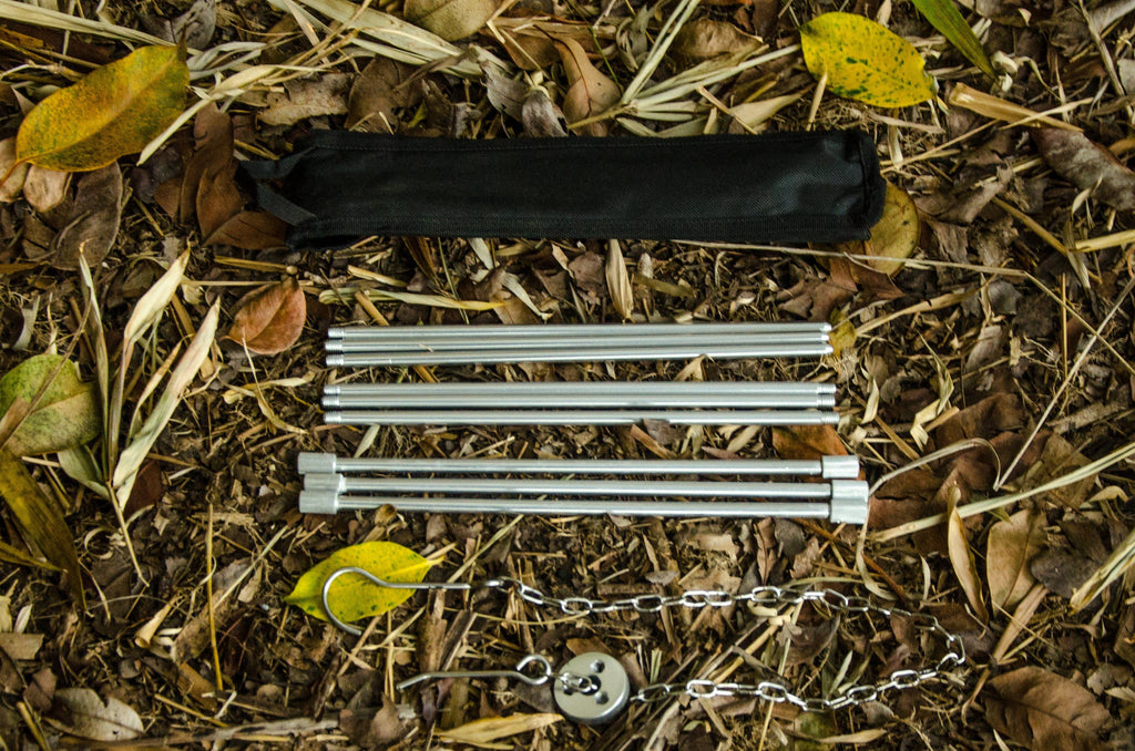 Over the fire hangs a pot in which to cook food. On a hook on a tripod,  steam comes out of the pan. Winter Camping outdoor cooking Stock Photo -  Alamy